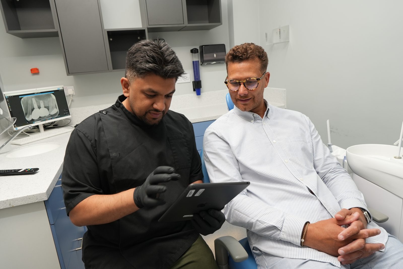 Dentist at Welling Dental Studio discussing treatment with a patient