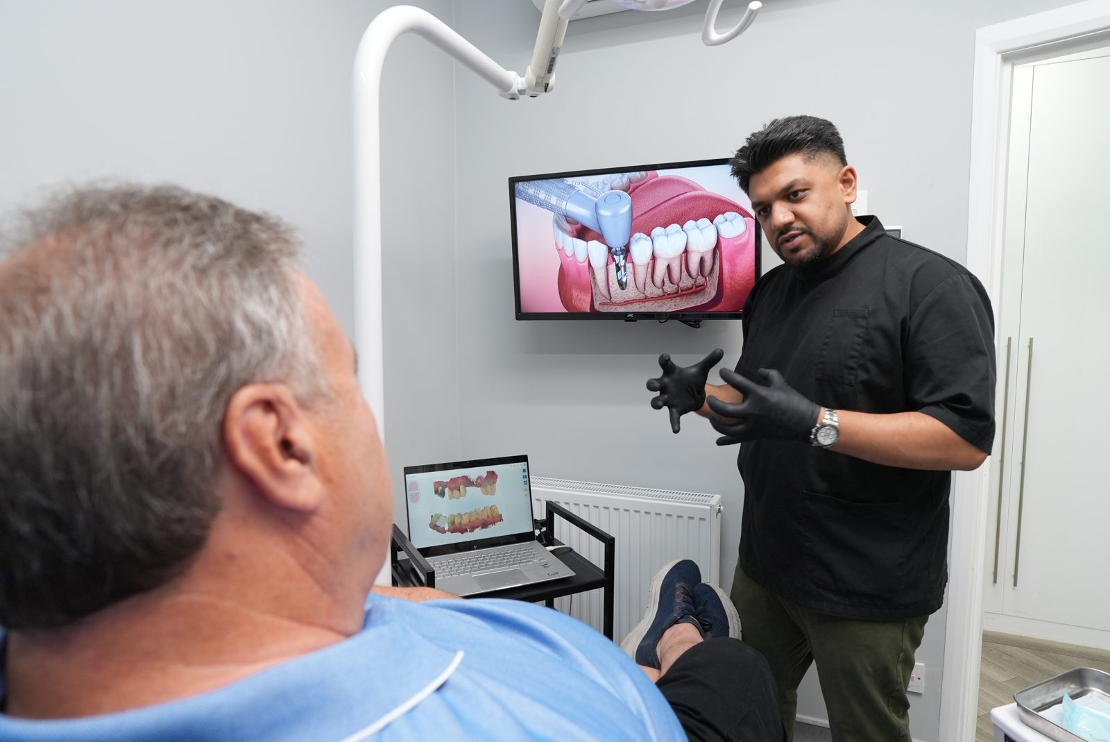 Dentist explaining a treatment plan to a patient at Welling Dental Studio